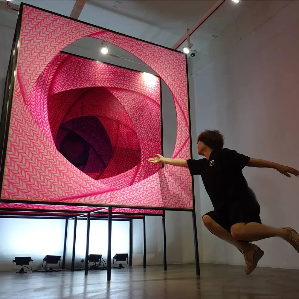 Artist interacting with the pink installation
